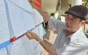Cụ ông 81 tuổi tỉ mỉ kiểm tra danh sách cử tri trước ngày bầu cử quan trọng